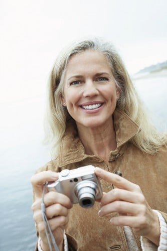 dental-implant-smiling-older-woman-camera