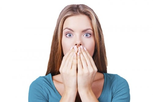 scared-woman-covering-her-mouth