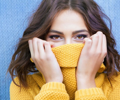 woman-pulling-sweater-up-covering-mouth